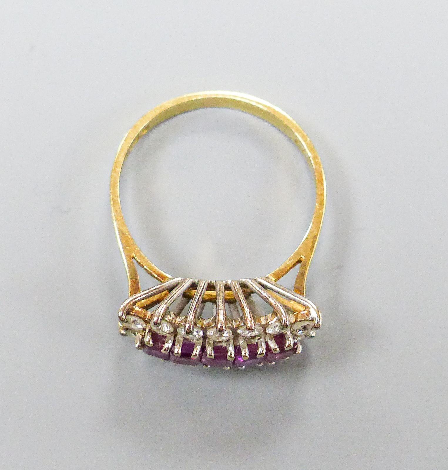 A modern 18ct gold, ruby and diamond half hoop cluster ring, size Q, gross weight 4.5 grams.